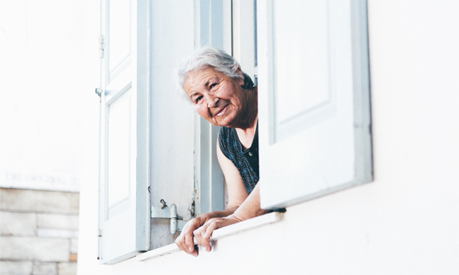 A lady leaning out of a window frame