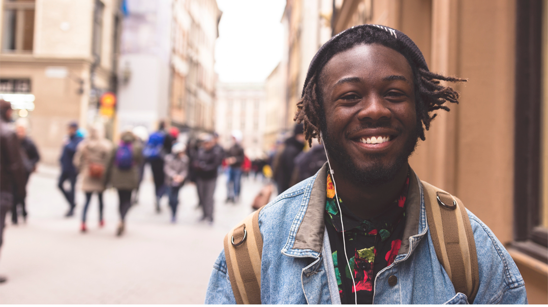an image of a smiling man with a group of people behind him