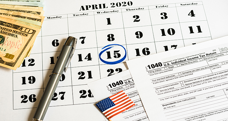 Composition on the day of tax payment in April with banknotes and tax form.